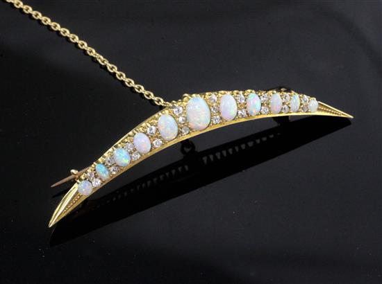 A Victorian style gold, graduated white opal and diamond set crescent brooch, 6cm.